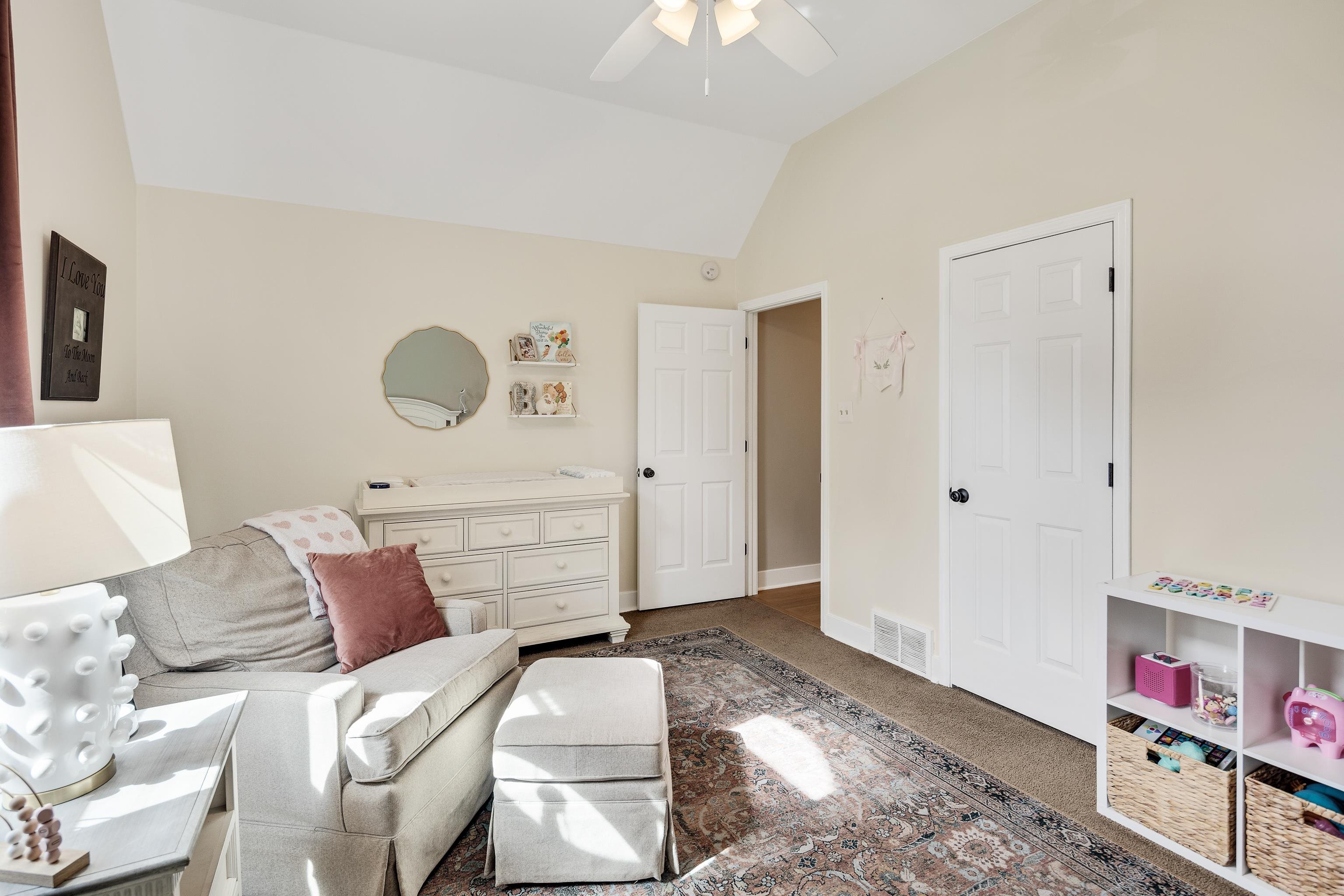 288 Hughes Cove Collierville, TN 38017 - Photo 21 of 31 Sitting room featuring vaulted ceiling, dark colored carpet, and a ceiling fan