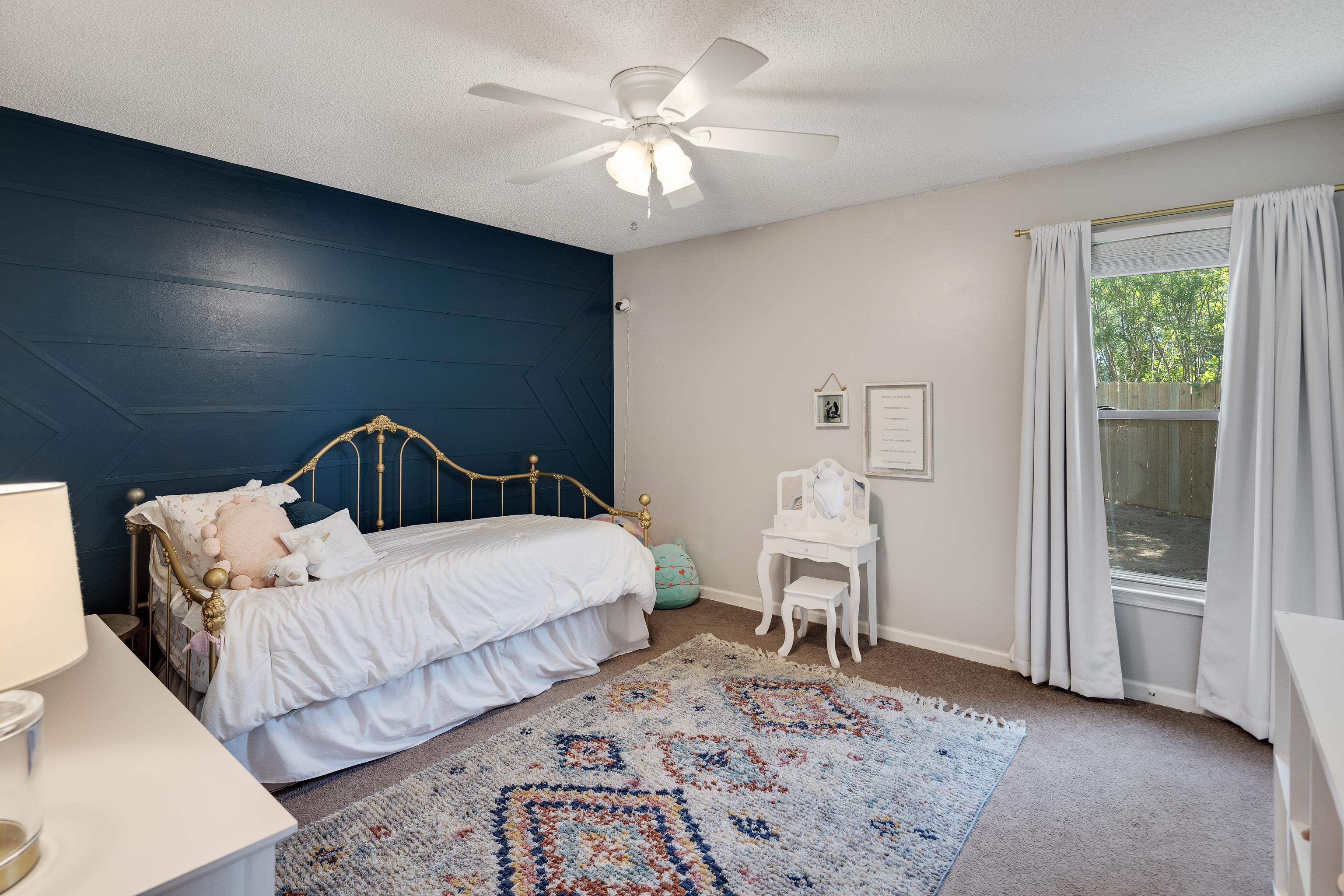 288 Hughes Cove Collierville, TN 38017 - Photo 24 of 31 Carpeted bedroom featuring an accent wall, a ceiling fan, and a textured ceiling