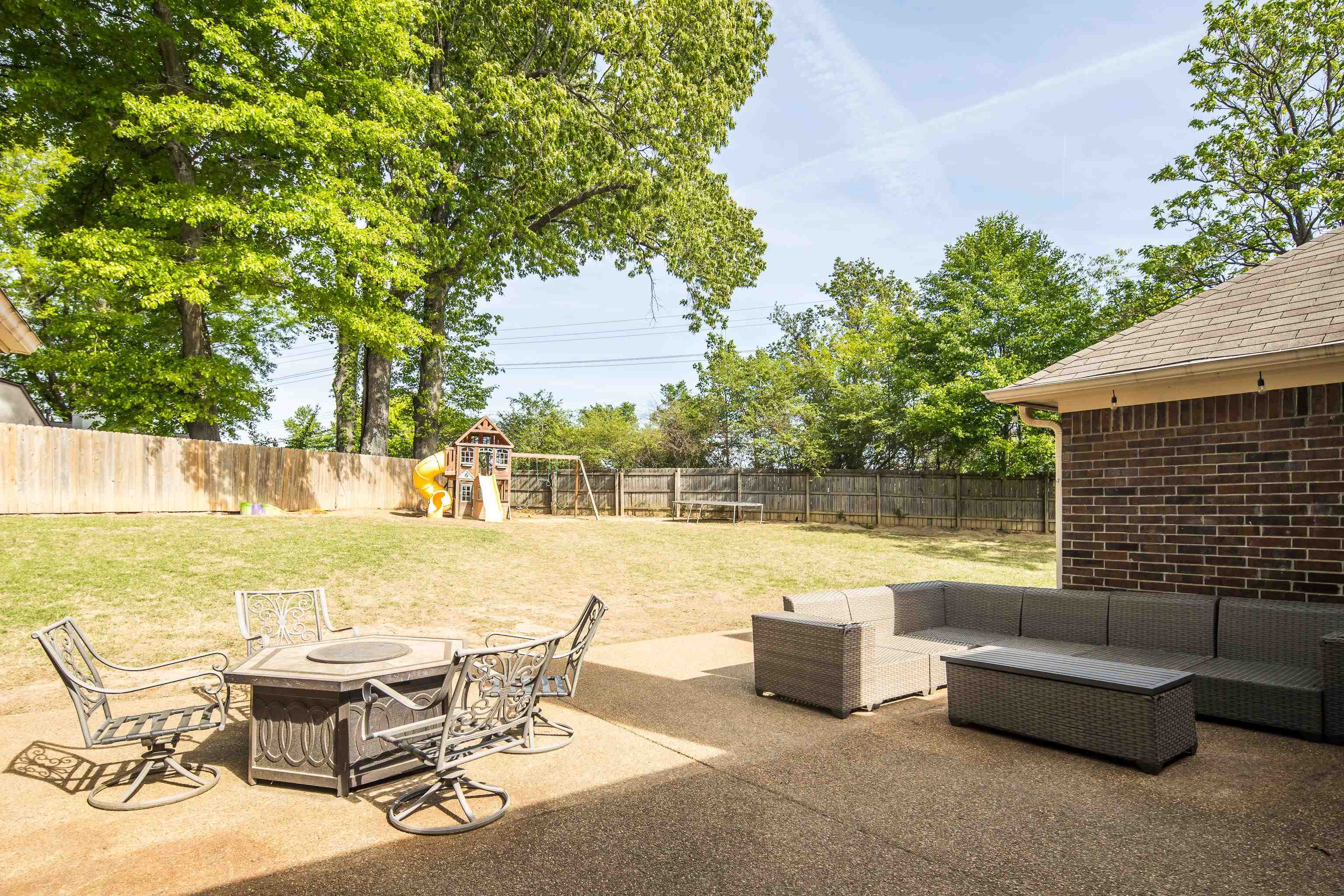288 Hughes Cove Collierville, TN 38017 - Photo 28 of 31 Fenced backyard with a patio area, an outdoor living space with a fire pit, and a playground
