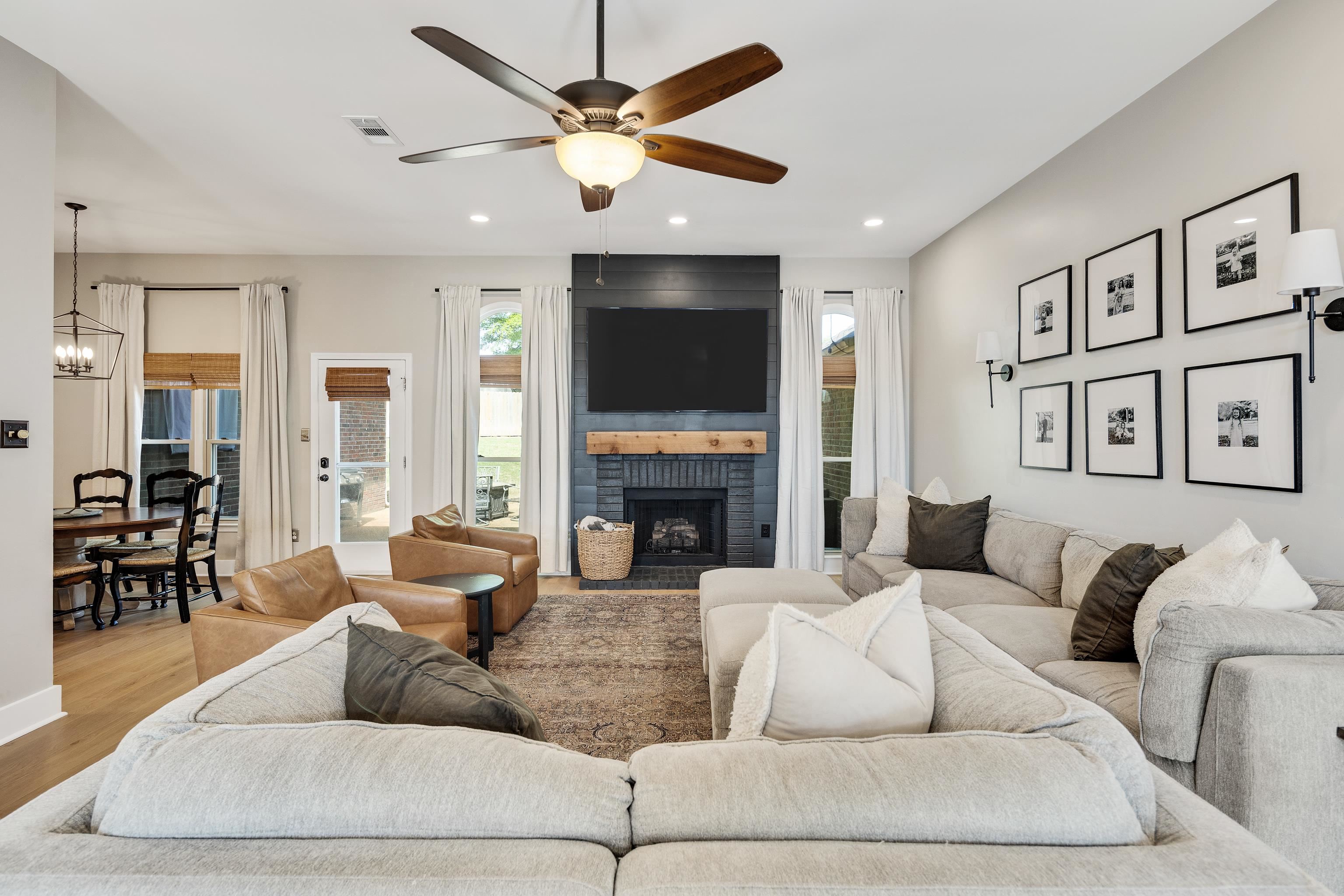 288 Hughes Cove Collierville, TN 38017 - Photo 6 of 31 Living room with ceiling fan, wood finished floors, a fireplace, and suspended lighting