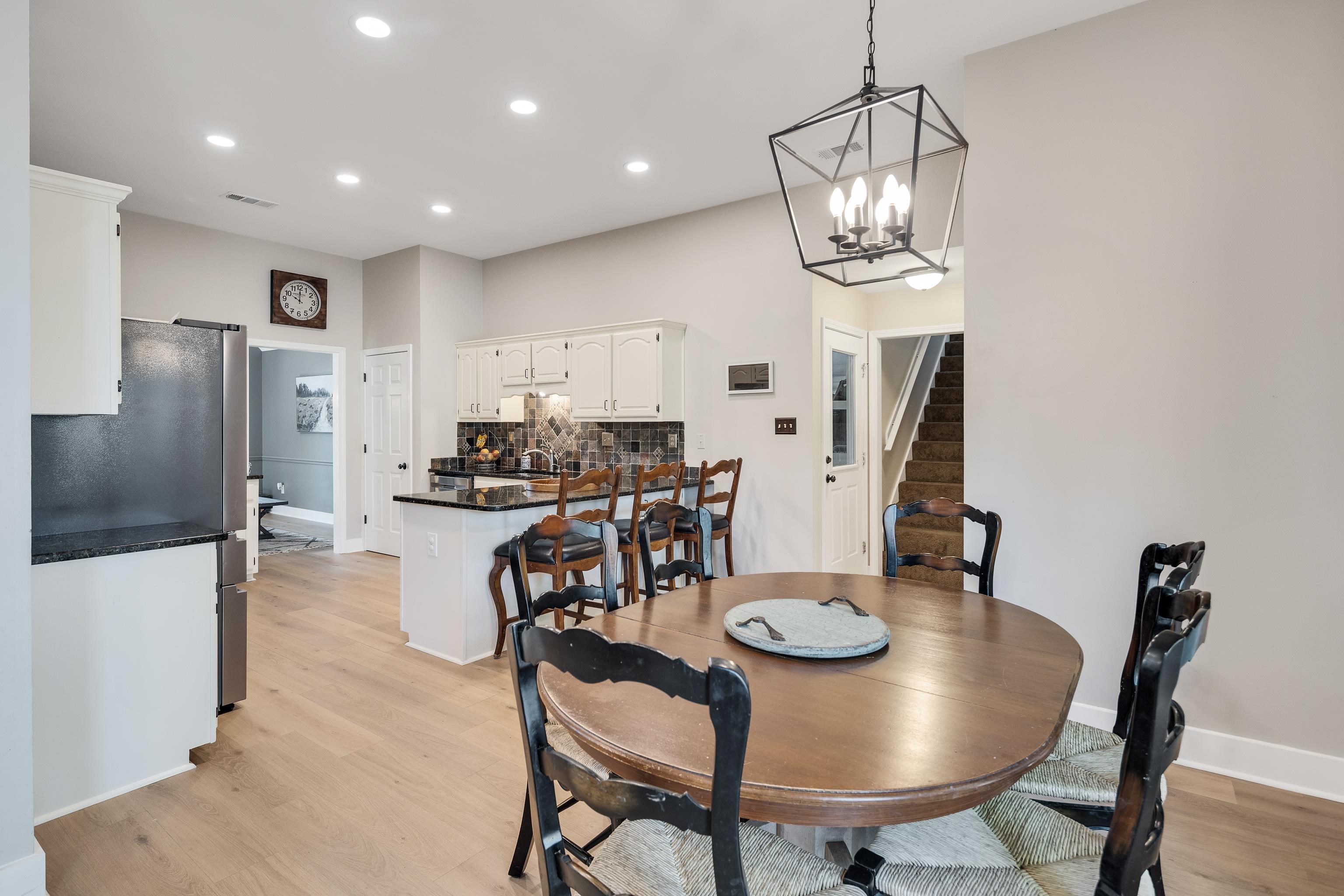 288 Hughes Cove Collierville, TN 38017 - Photo 10 of 31 Dining space featuring light wood-style floors and a chandelier