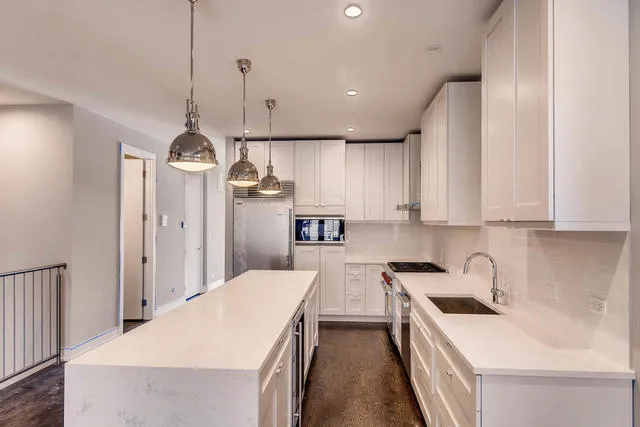a kitchen with a sink a stove and refrigerator