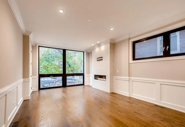 wooden floor in an empty room with a window