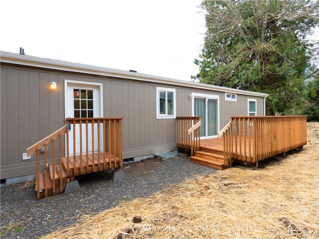 a view of a house with a backyard and deck