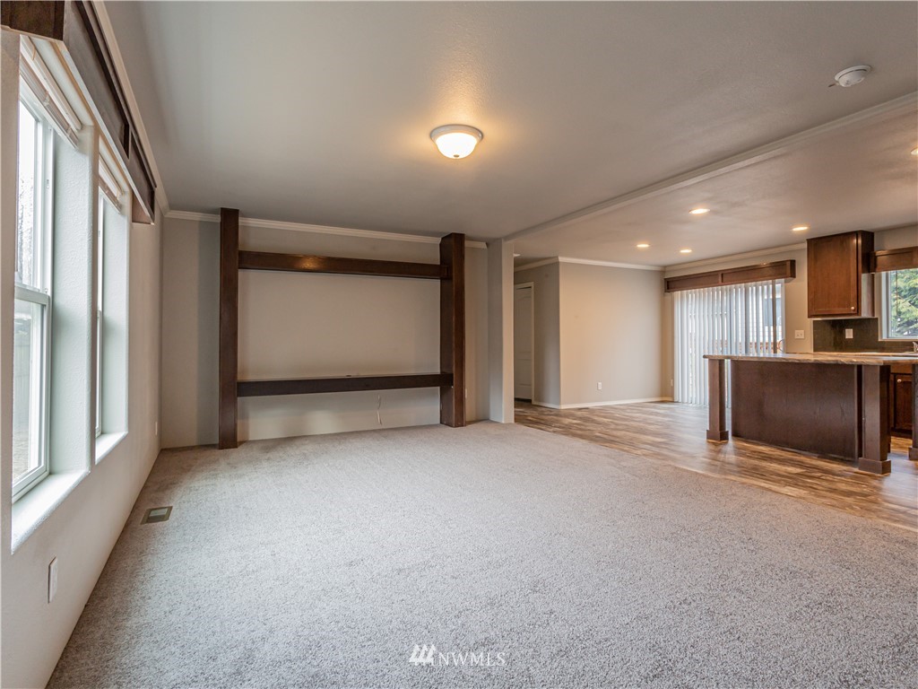 4547 Decatur Drive Ferndale, WA 98248 - Photo 14 of 30 a view of an empty room with a fireplace and a window