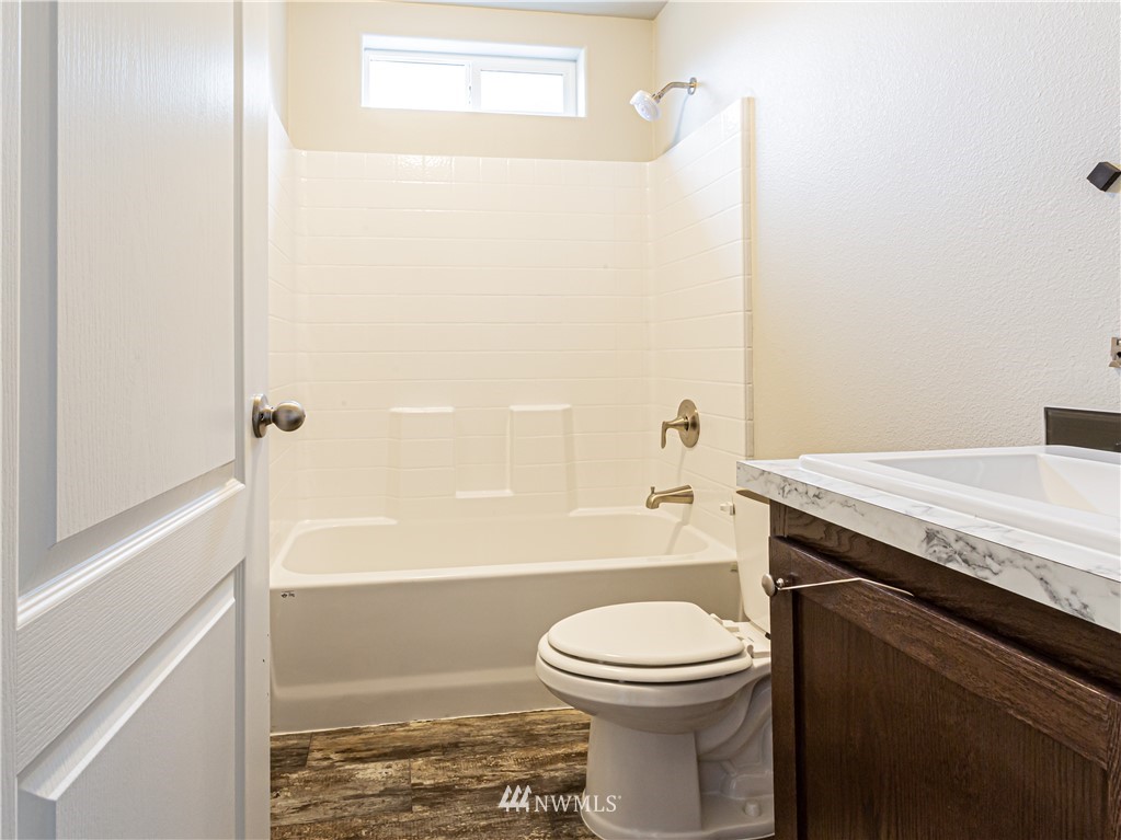 4547 Decatur Drive Ferndale, WA 98248 - Photo 20 of 30 a bathroom with a granite countertop toilet a sink and bathtub