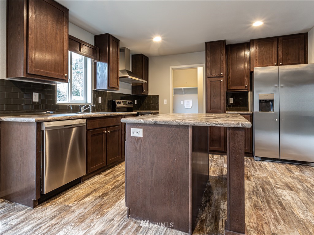 4547 Decatur Drive Ferndale, WA 98248 - Photo 4 of 30 a kitchen with stainless steel appliances granite countertop a stove a sink and a refrigerator