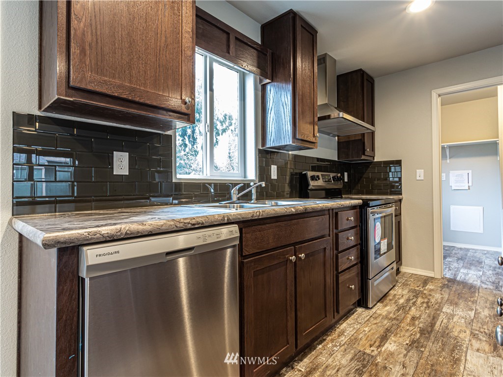 4547 Decatur Drive Ferndale, WA 98248 - Photo 5 of 30 a kitchen with stainless steel appliances granite countertop a sink stove and cabinets