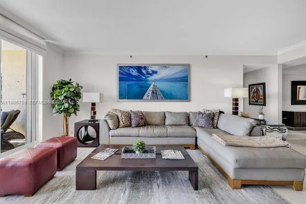 a living room with furniture and a potted plant