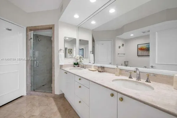 a bathroom with a granite countertop sink mirror and double