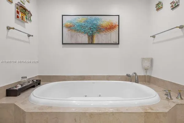 a white bath tub sitting next to a white sink