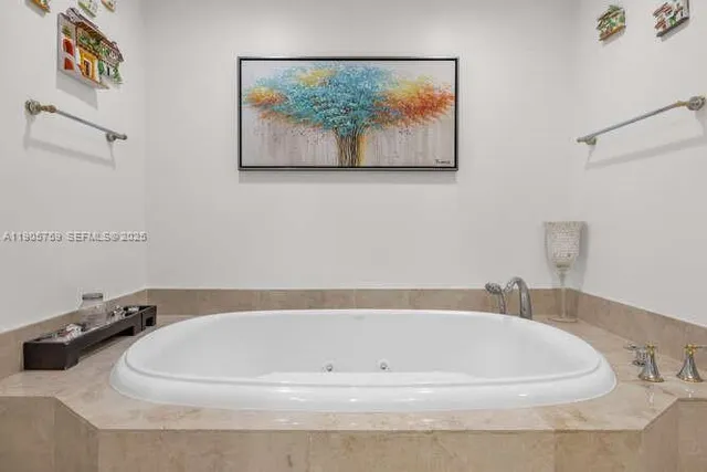 a white bath tub sitting next to a white sink