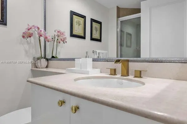 a bathroom with a sink vanity and a mirror