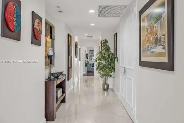 a view of entryway with paintings on wall