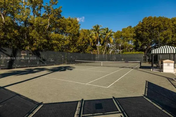 a view of a tennis court with trees in the background