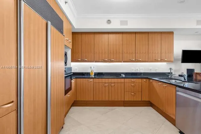 a kitchen with stainless steel appliances granite countertop a refrigerator a sink and dishwasher