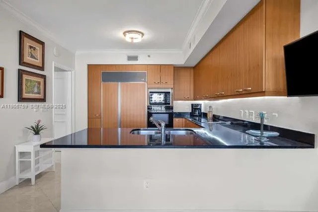 a kitchen with a refrigerator and a sink