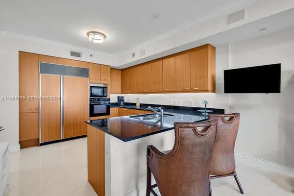 a kitchen with stainless steel appliances granite countertop a sink a stove and a refrigerator
