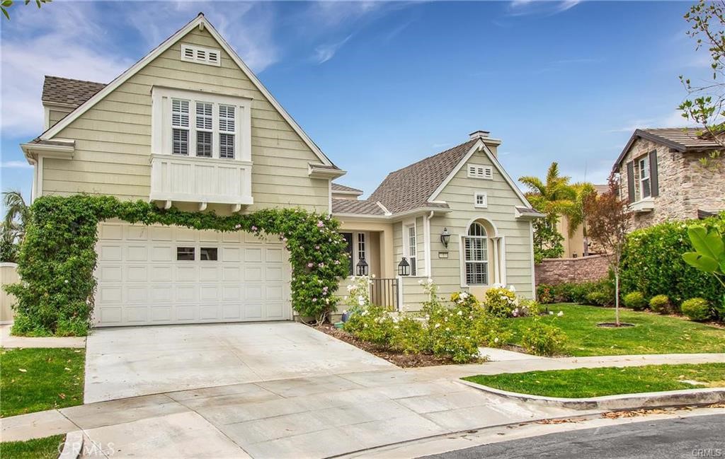 a view of a white house next to a yard and trees
