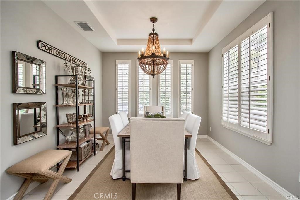3 Weldon Heights Ladera Ranch, CA 92694 - Photo 2 of 13 a dining room with wooden floor and a chandelier