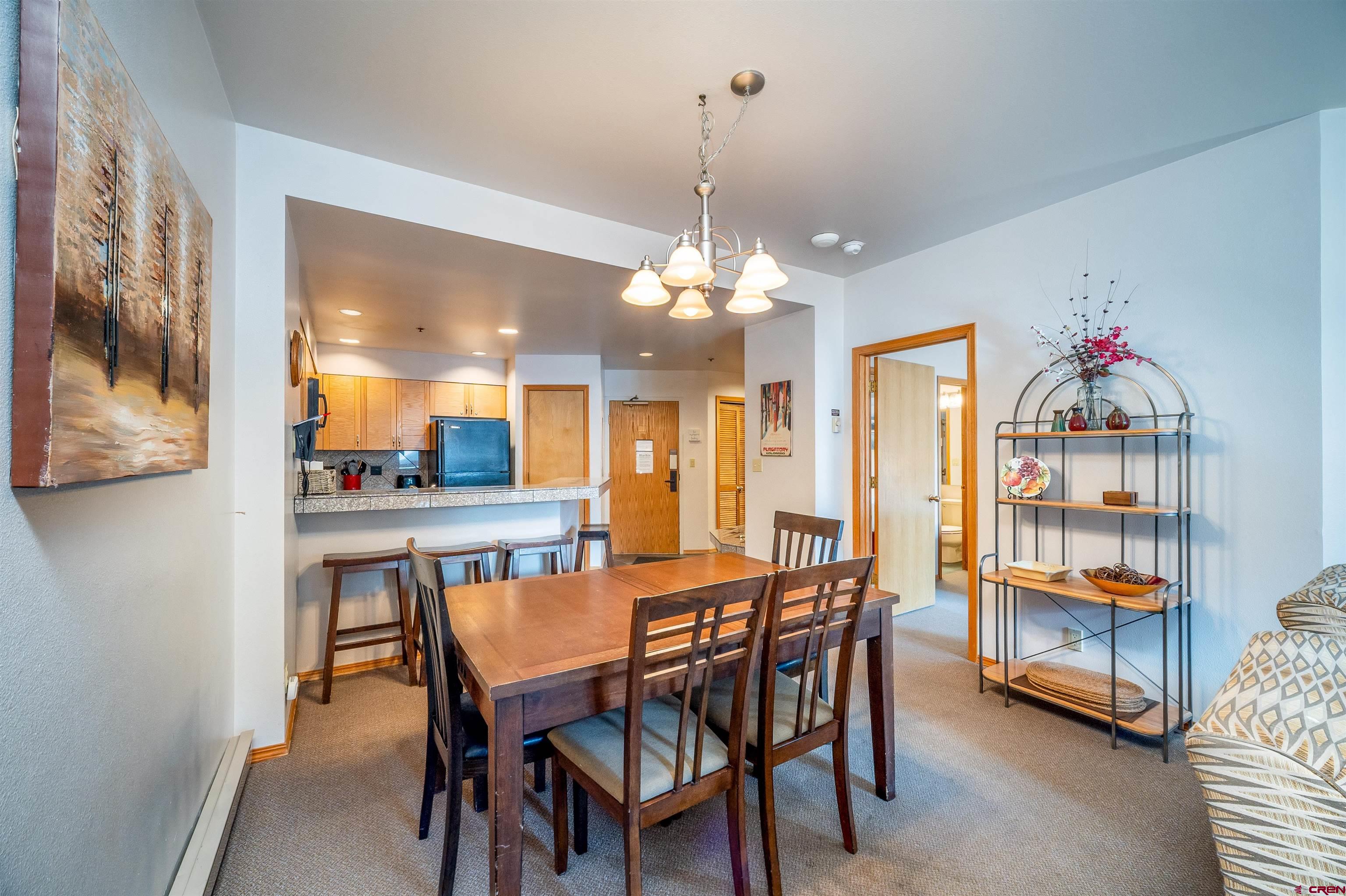 71 East Needles Road, Unit 331 Durango, CO 81301 - Photo 4 of 40 a dining room with stainless steel appliances kitchen island a table and chairs