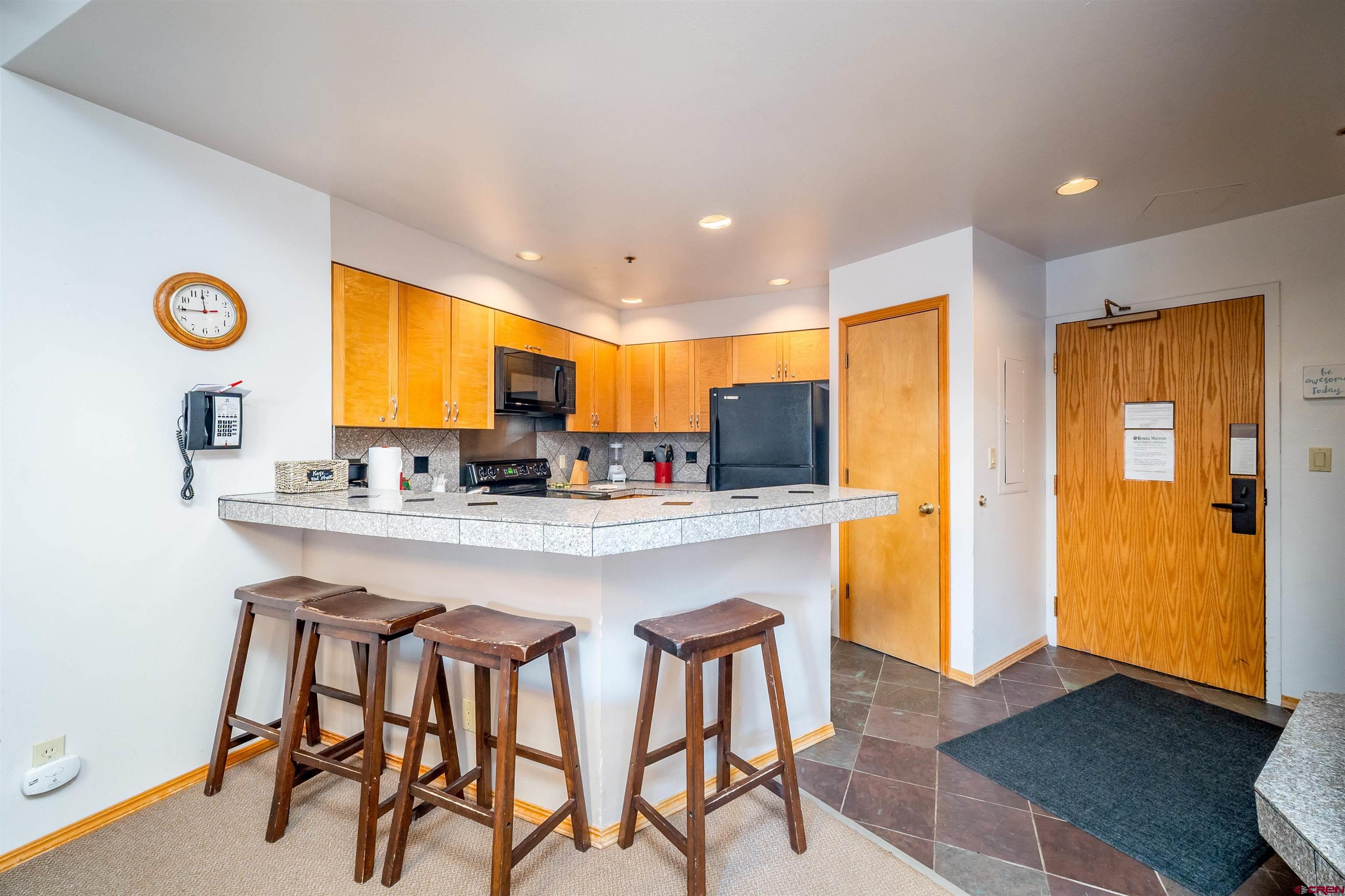 71 East Needles Road, Unit 331 Durango, CO 81301 - Photo 5 of 40 a kitchen with stainless steel appliances granite countertop a table and chairs in it