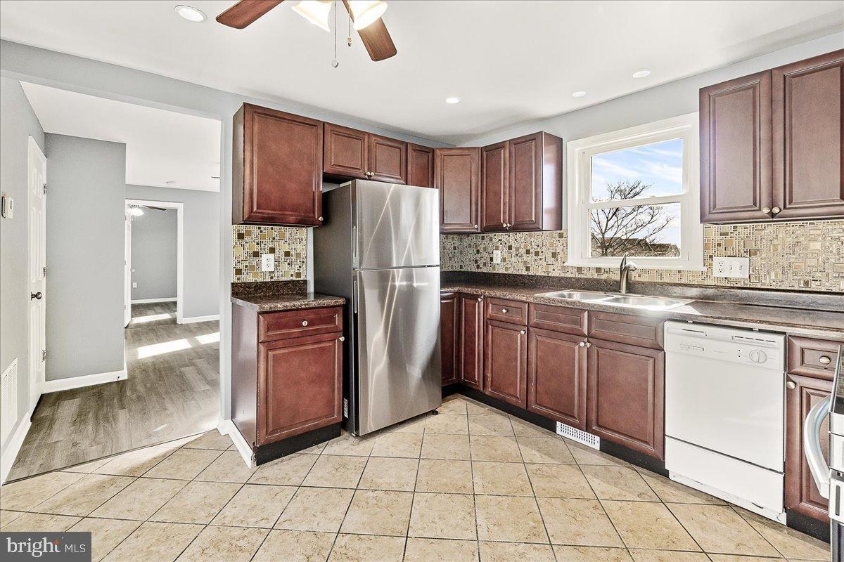 22310 Clarksburg Road Boyds, MD 20841 - Photo 12 of 47 a kitchen with stainless steel appliances granite countertop a refrigerator sink and cabinets