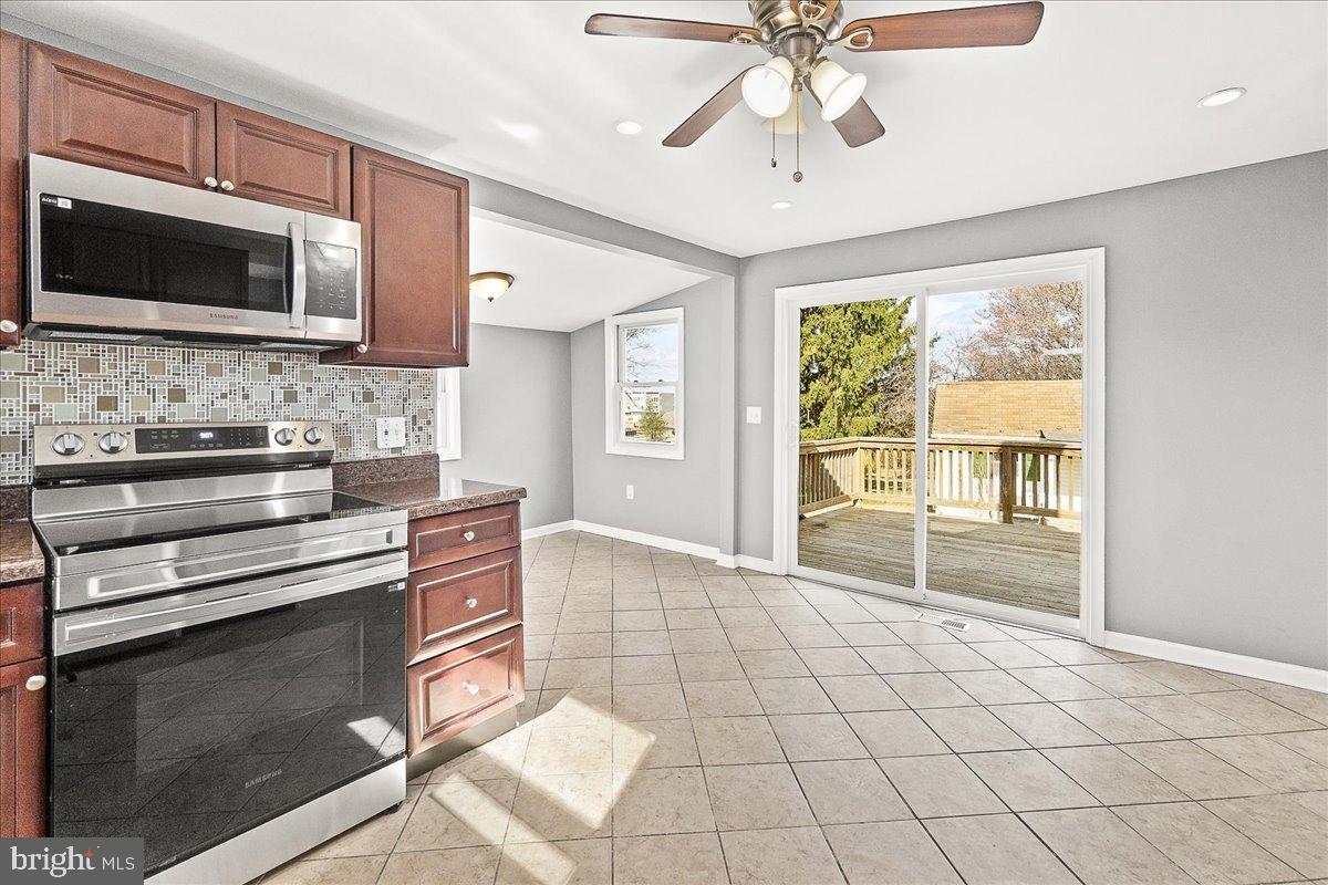 22310 Clarksburg Road Boyds, MD 20841 - Photo 15 of 47 a kitchen with stainless steel appliances a stove microwave and cabinets