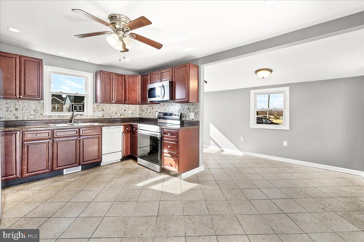 22310 Clarksburg Road Boyds, MD 20841 - Photo 16 of 47 a kitchen with stainless steel appliances granite countertop a stove sink and cabinets