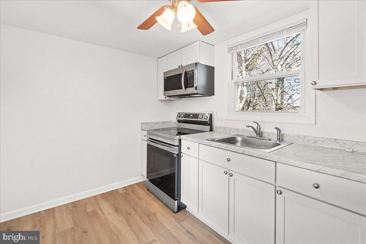 22310 Clarksburg Road Boyds, MD 20841 - Photo 35 of 47 a kitchen with a sink cabinets and stainless steel appliances