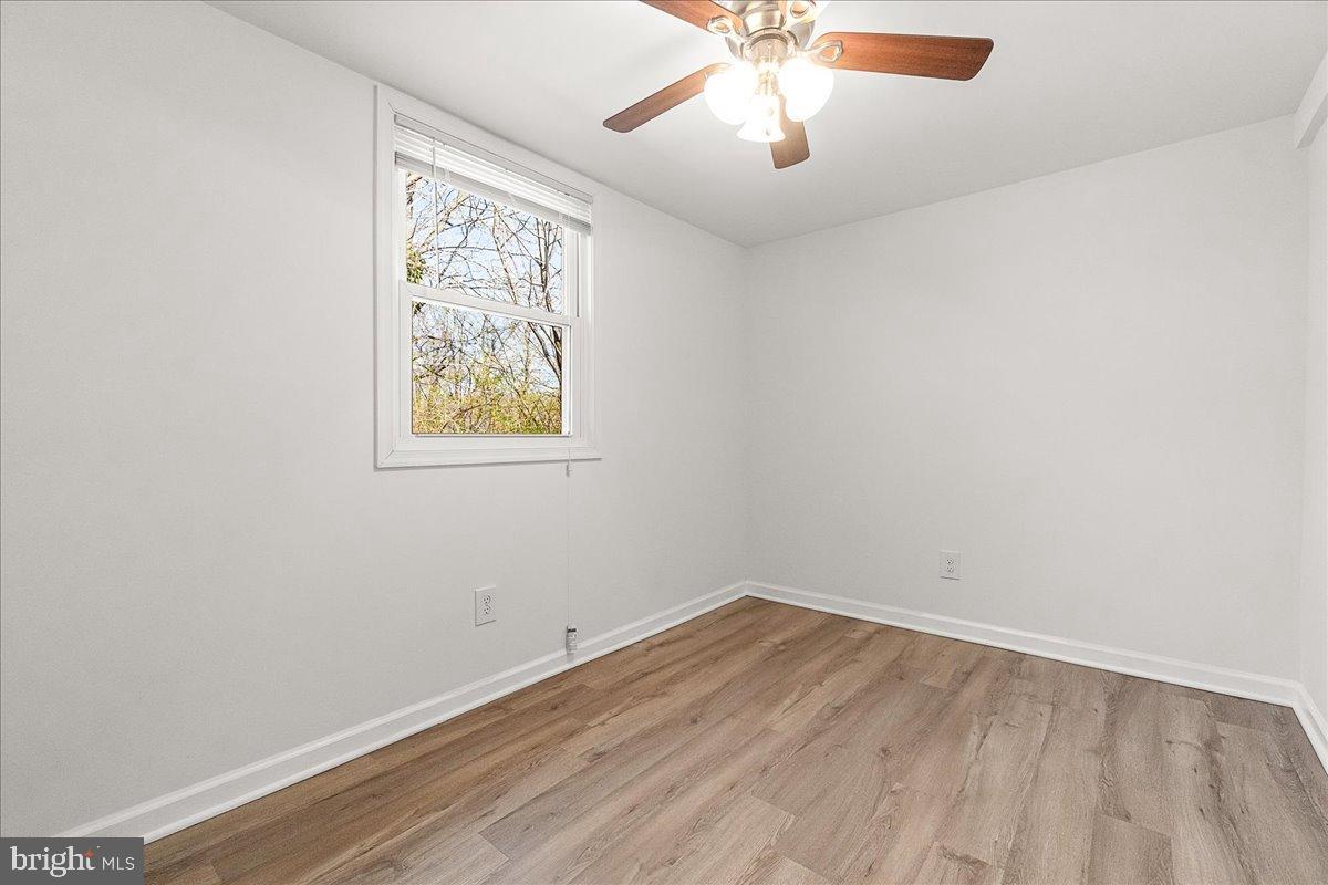 22310 Clarksburg Road Boyds, MD 20841 - Photo 41 of 47 an empty room with a window and a ceiling fan