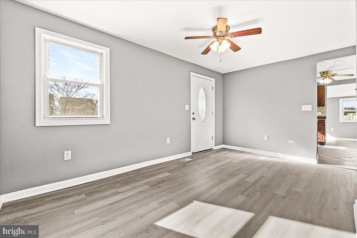22310 Clarksburg Road Boyds, MD 20841 - Photo 8 of 47 a view of an empty room with window and a chandelier fan