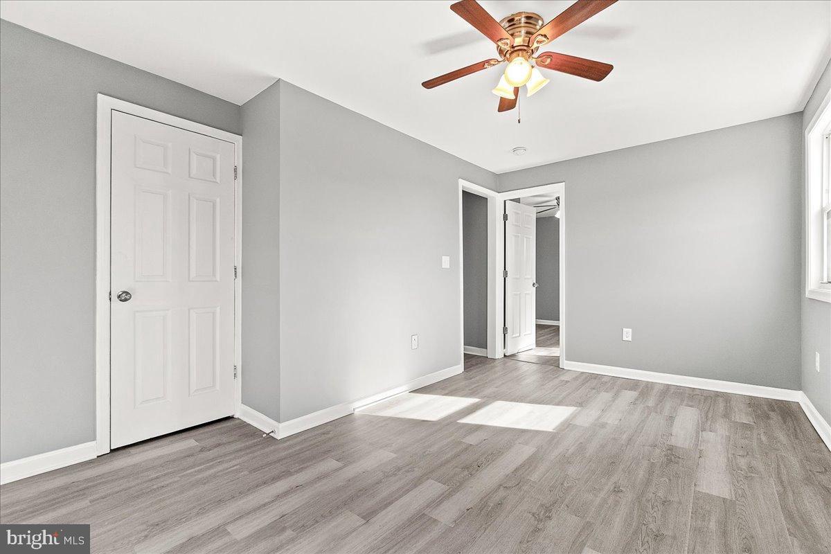 22310 Clarksburg Road Boyds, MD 20841 - Photo 10 of 47 a view of an empty room with window and wooden floor