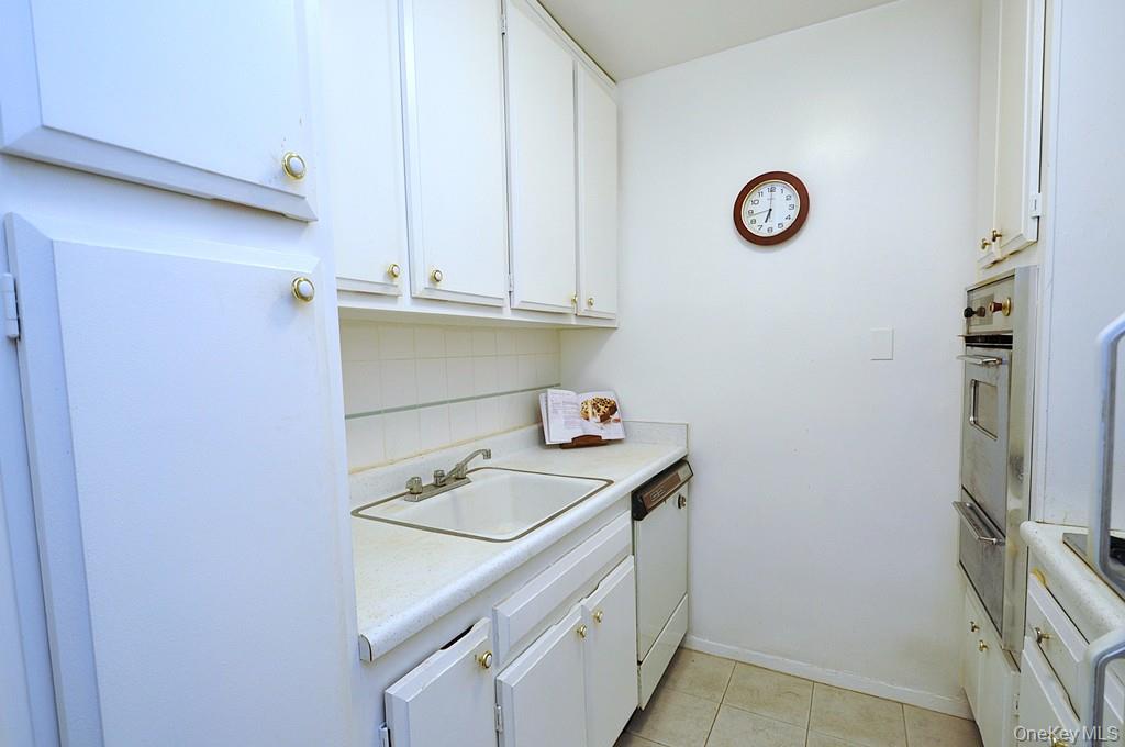 260 Garth Road, Unit 4A5 Scarsdale, NY 10583 - Photo 12 of 35 a kitchen with a sink and a stove top oven