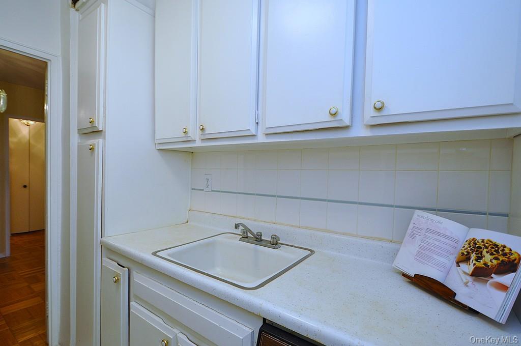 260 Garth Road, Unit 4A5 Scarsdale, NY 10583 - Photo 13 of 35 a kitchen with a sink and cabinets