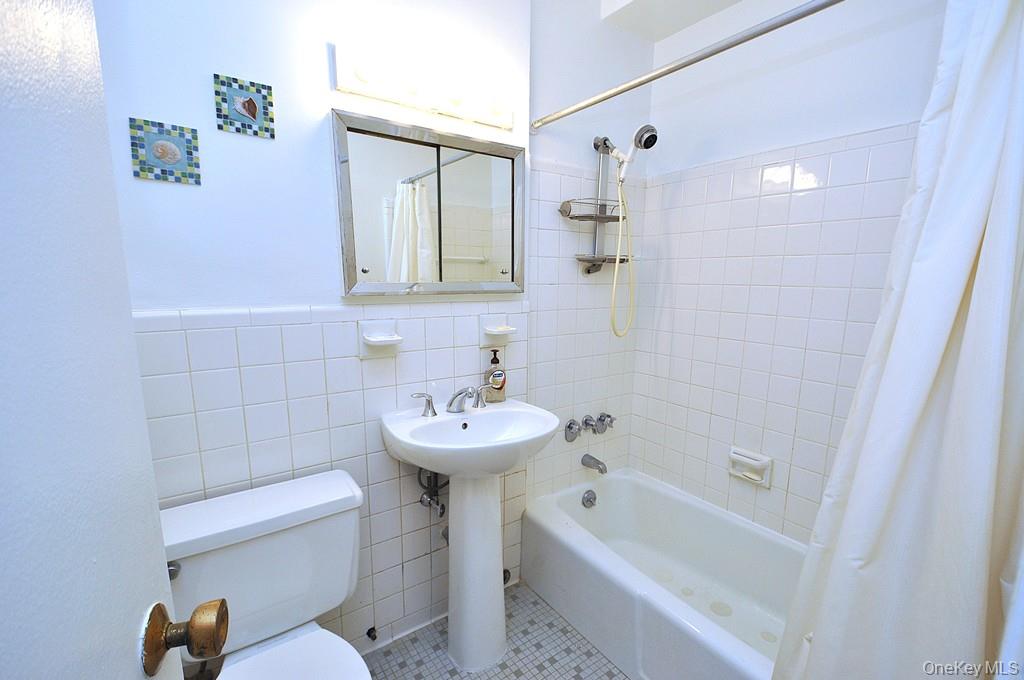 260 Garth Road, Unit 4A5 Scarsdale, NY 10583 - Photo 16 of 35 a bathroom with a sink a toilet and shower