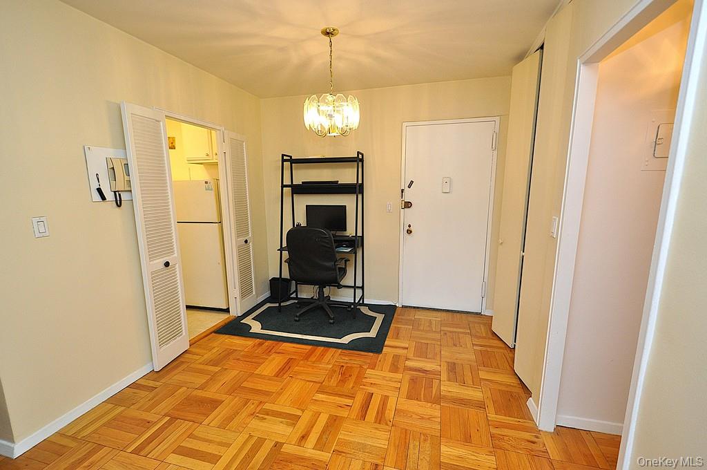 260 Garth Road, Unit 4A5 Scarsdale, NY 10583 - Photo 18 of 35 a view of a gallery with wooden floor and door