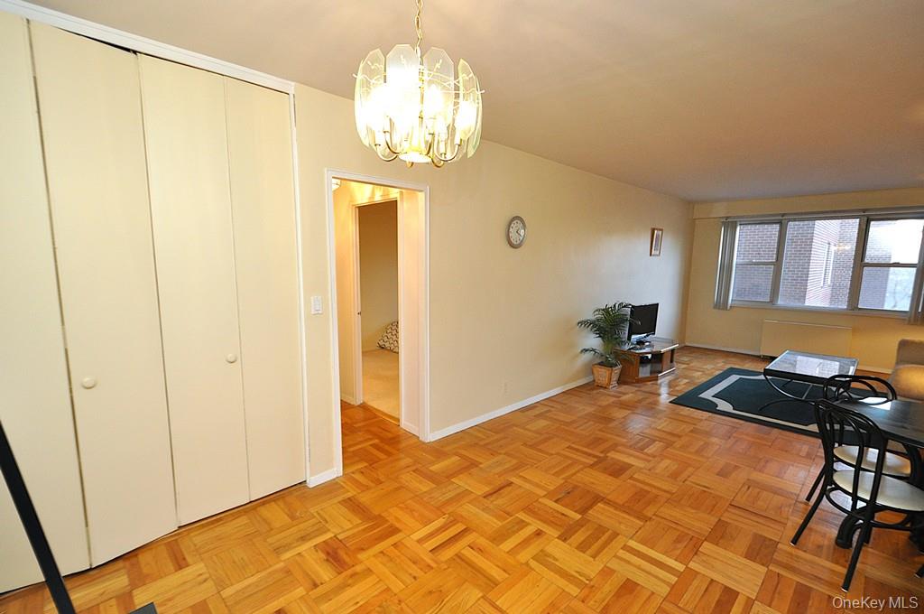 260 Garth Road, Unit 4A5 Scarsdale, NY 10583 - Photo 20 of 35 a bedroom with a bed and a chandelier