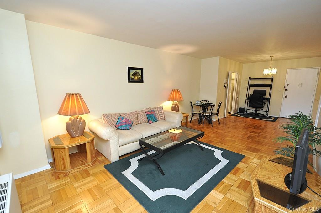260 Garth Road, Unit 4A5 Scarsdale, NY 10583 - Photo 3 of 35 a living room with furniture and a lamp