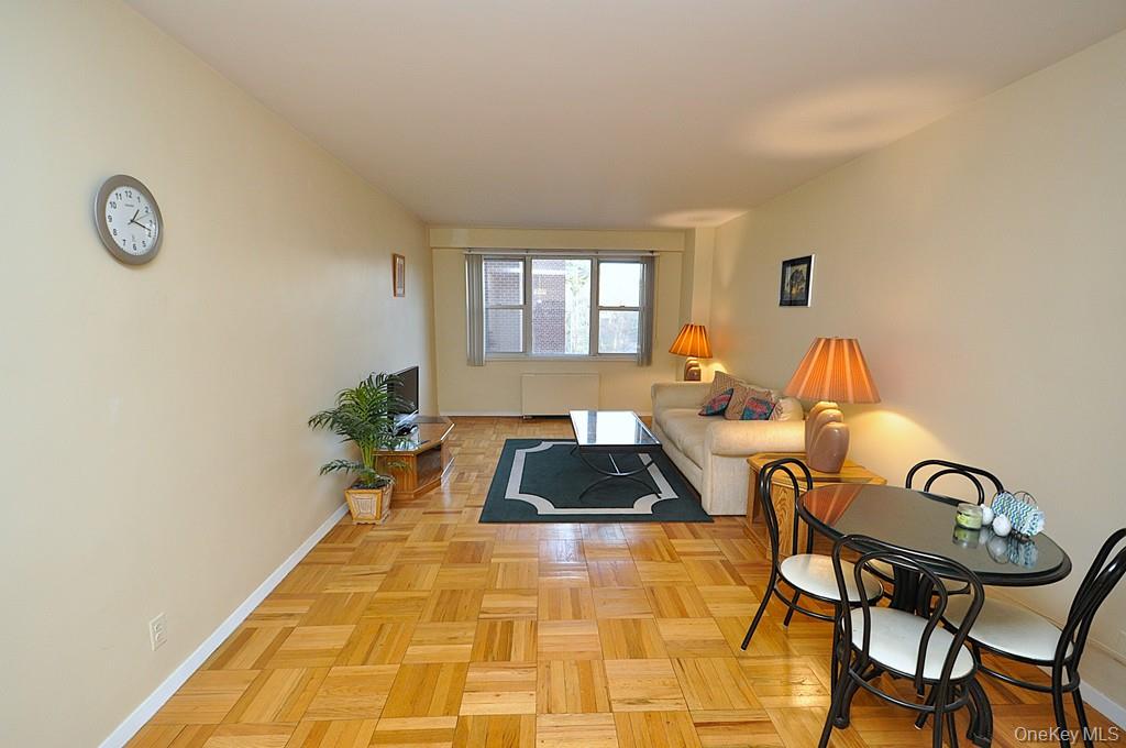 260 Garth Road, Unit 4A5 Scarsdale, NY 10583 - Photo 6 of 35 a bedroom with a bed and dresser with wooden floor
