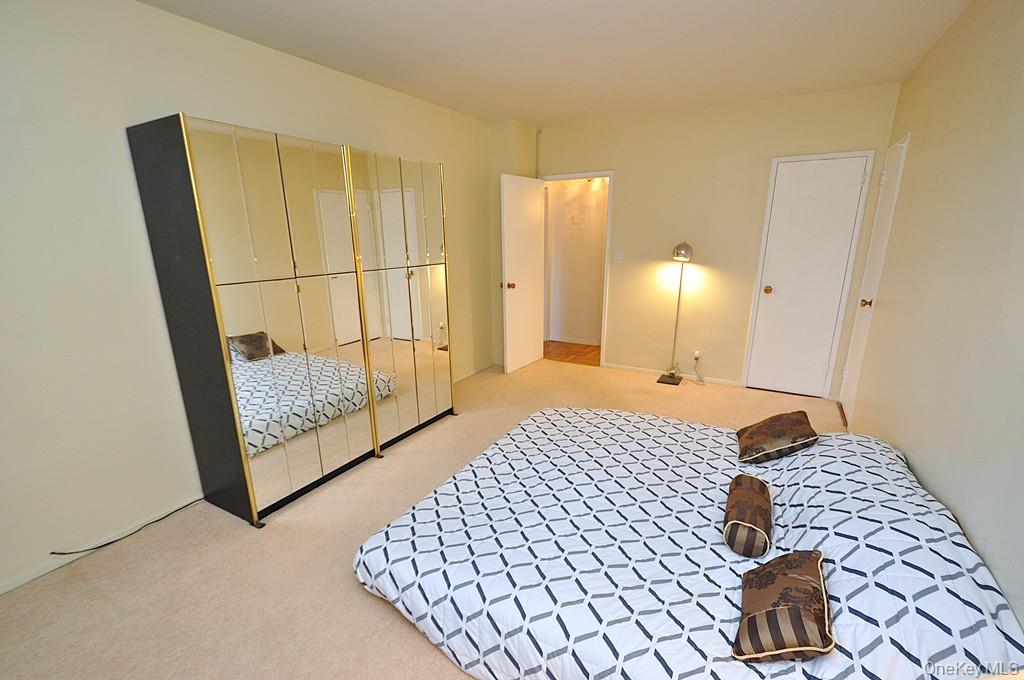 260 Garth Road, Unit 4A5 Scarsdale, NY 10583 - Photo 10 of 35 a bedroom with a bed and wooden floor