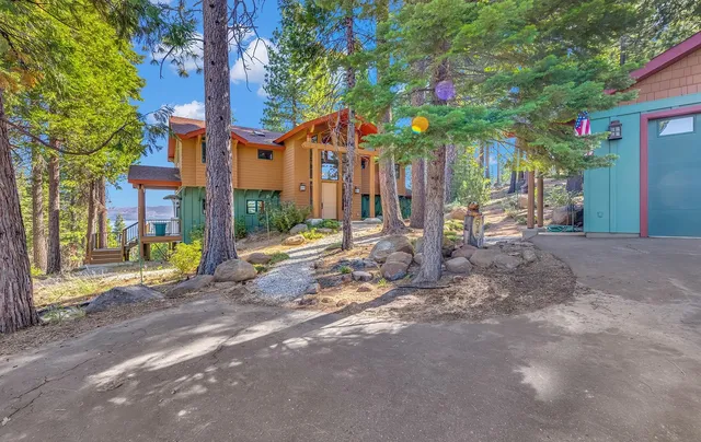 a view of a house with a tree and a yard