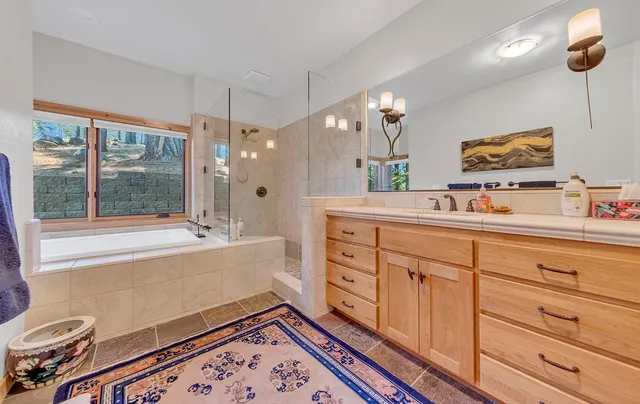 a spacious bathroom with double vanity and a mirror