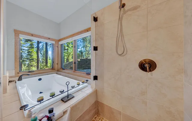 a bathroom with a tub and a shower