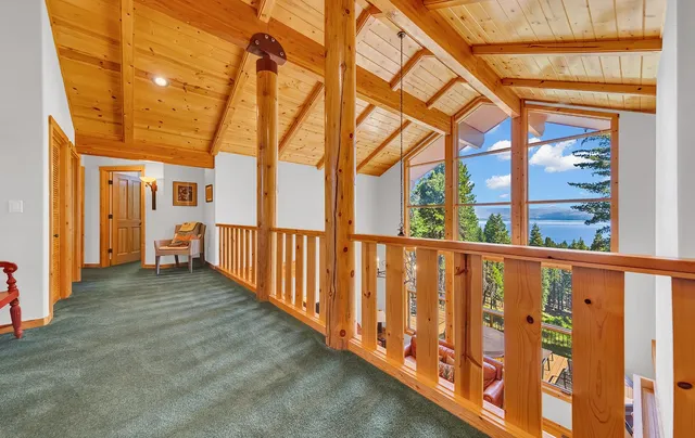 a view of a porch with wooden floor and fence