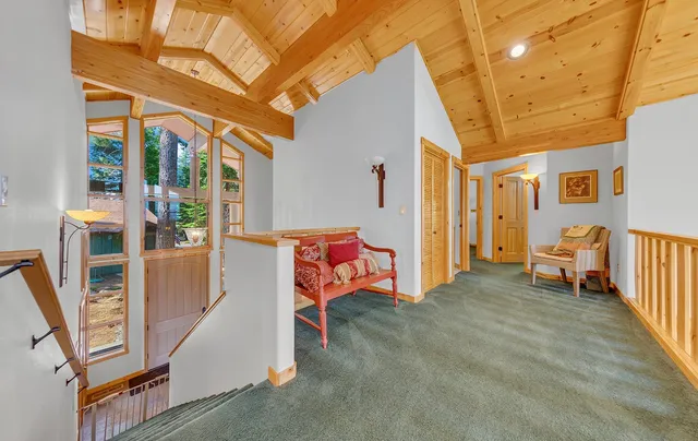 a view of a porch with furniture and a backyard