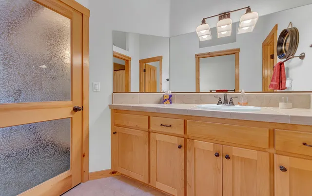 a bathroom with a double vanity sink mirror and