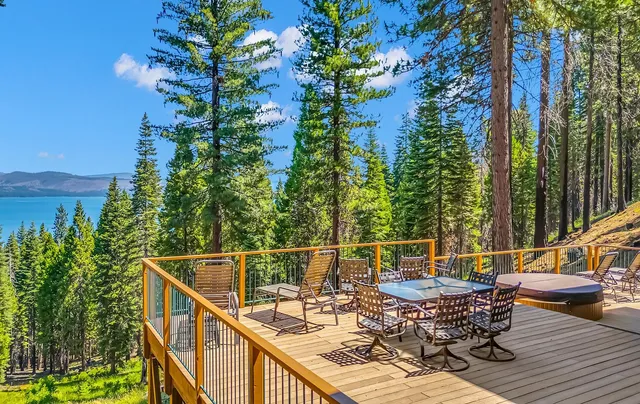a view of deck with furniture and trees
