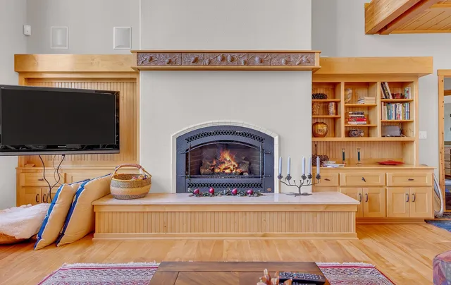 a living room with fireplace furniture and a flat screen tv