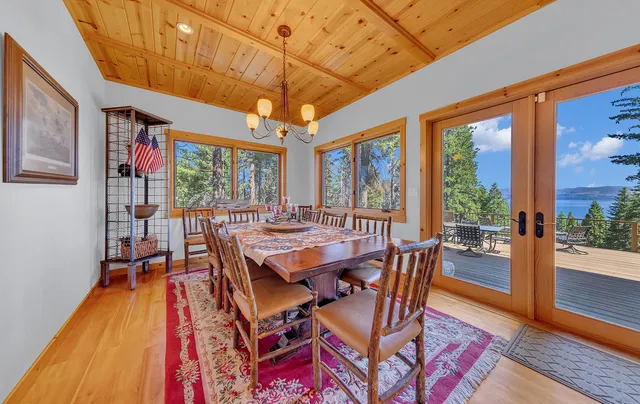 a dining room with furniture a chandelier and wooden floor